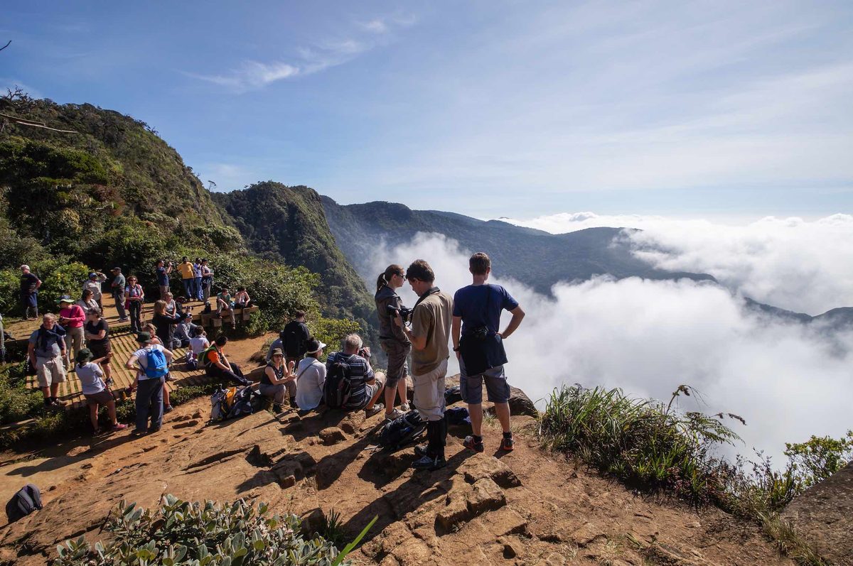 Visitors at the World’s End cliff above the clouds